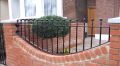 TF12 railings on a red-brick front wall