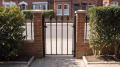 MN188 side gate, hung between brick piers
