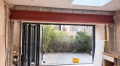 Fabricated steel beam installed over a wide glazed opening in a domestic extension