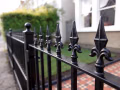 Wrought iron railings with fleur-de-lis finials fronting a period London property